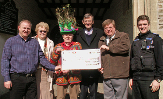 Pilton festival receiving cheque from Barnstaple Town Councillors